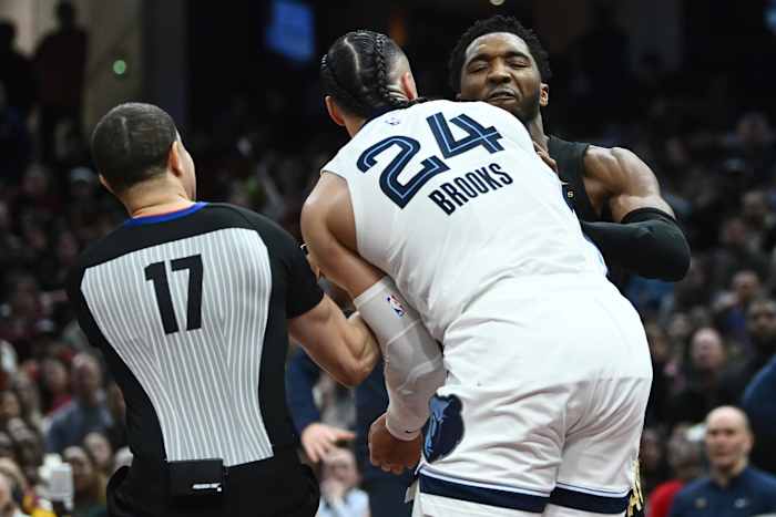 Feb 2, 2023; Cleveland, Ohio, USA; Cleveland Cavaliers guard Donovan Mitchell (45) fights with Memphis Grizzlies forward Dillon Brooks (24) as referee Jonathan Sterling (17) tries to break them apart during the second half at Rocket Mortgage FieldHouse.